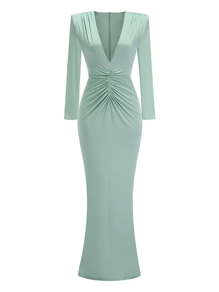 Mint green dress with long sleeves on a white background