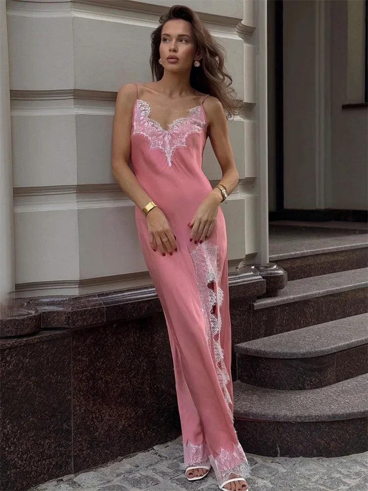 Woman wearing a pink lace nightgown standing on steps.