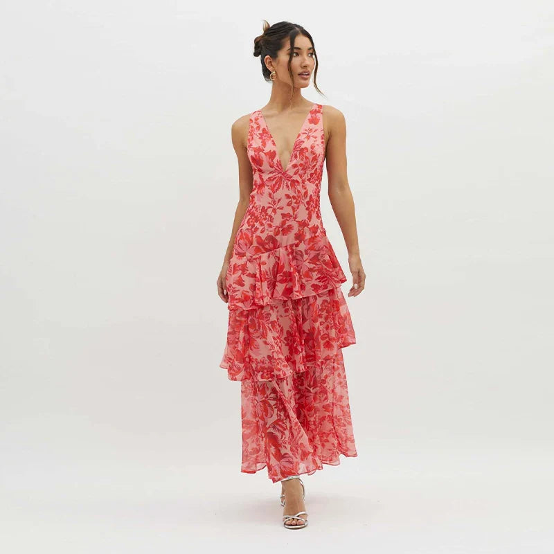 Woman wearing a red floral dress on a white background