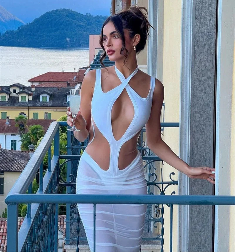 Woman in a white dress standing on a balcony with a scenic background