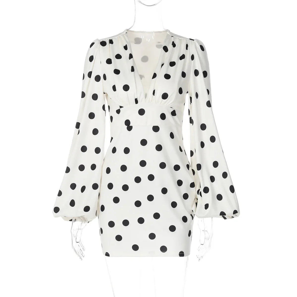 White dress with black polka dot pattern on a white background