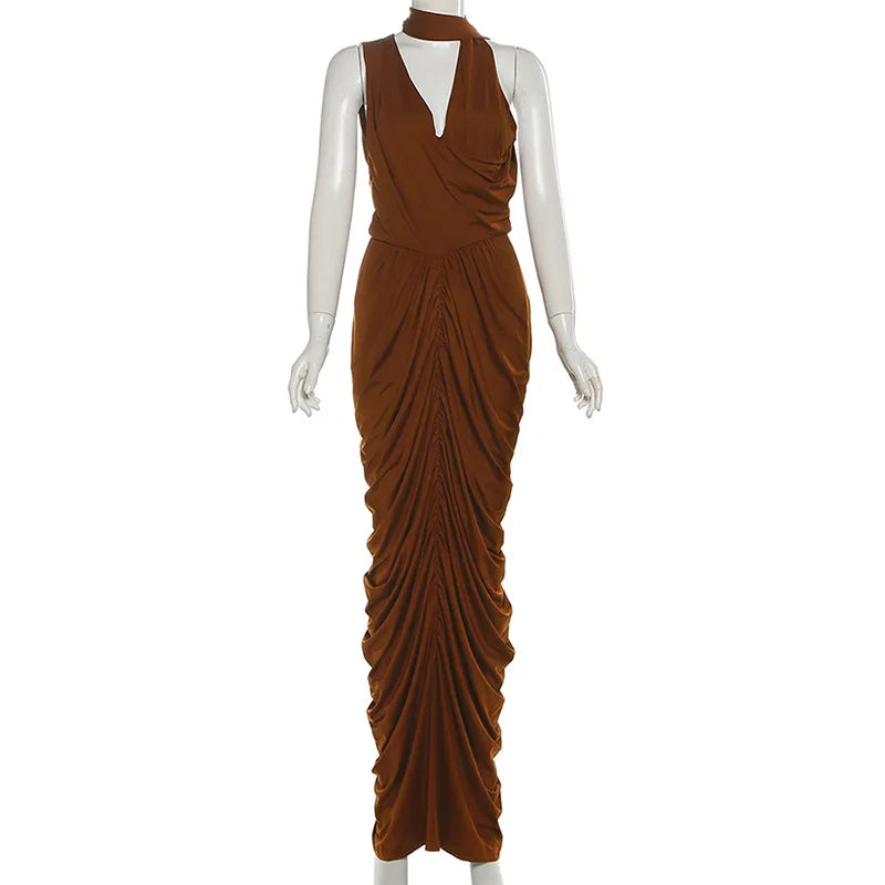 Brown draped evening gown on a mannequin against a white background