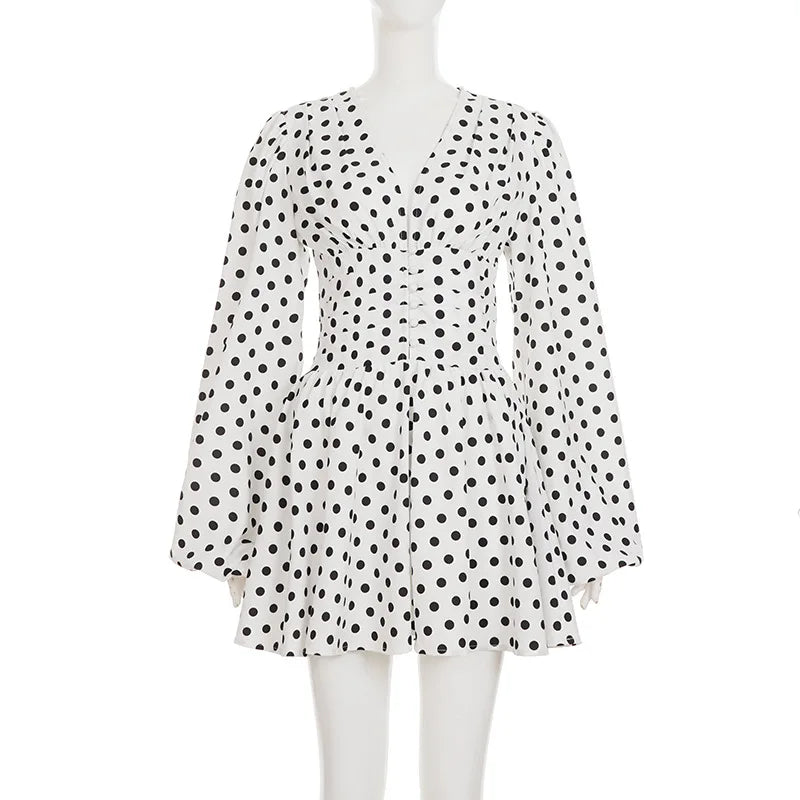 White dress with black polka dots on a mannequin against a white background