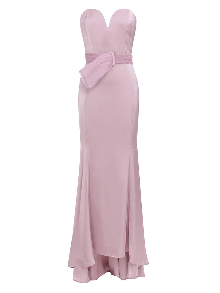 Pink strapless gown with a bow detail on a white background