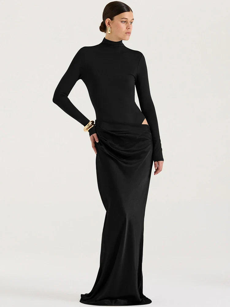 Woman wearing a black long-sleeve top and black pencil skirt on a white background