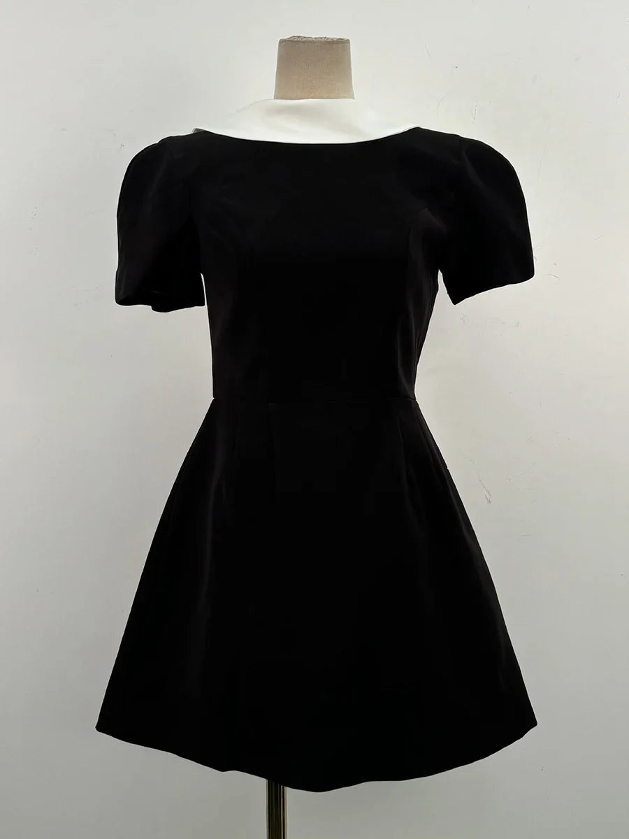 Black dress on a mannequin against a white background