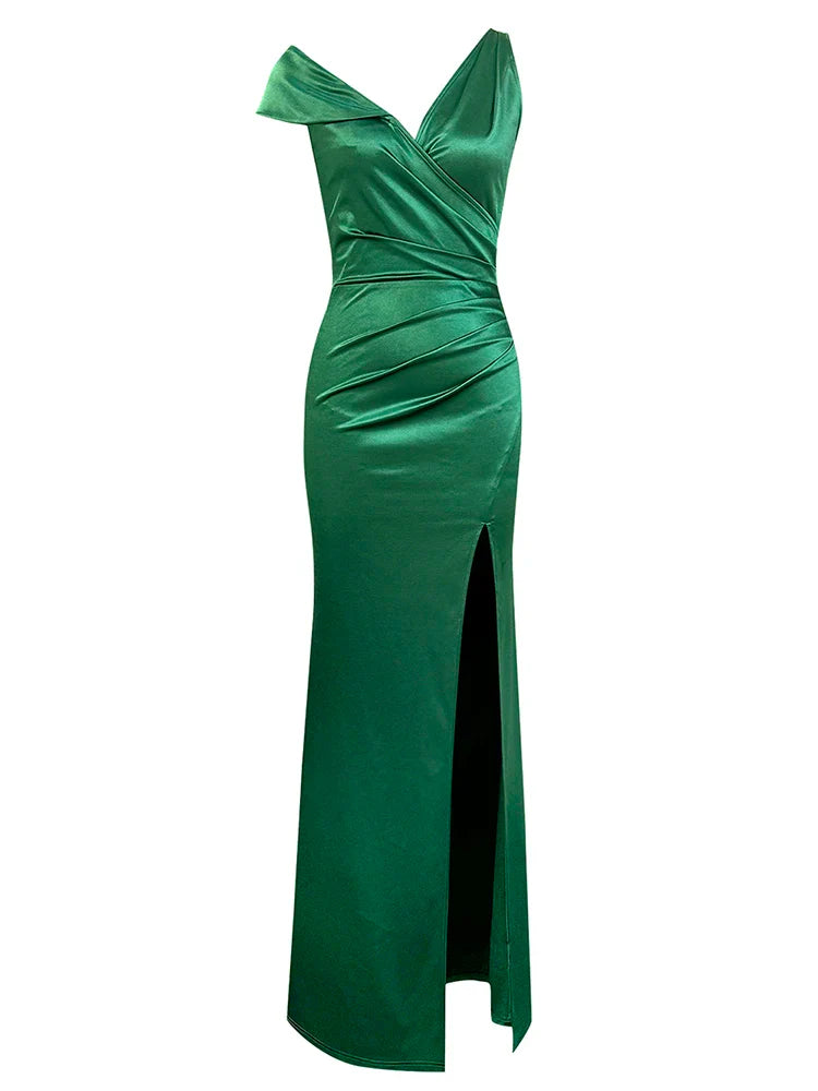 Green evening gown with a high slit on a white background