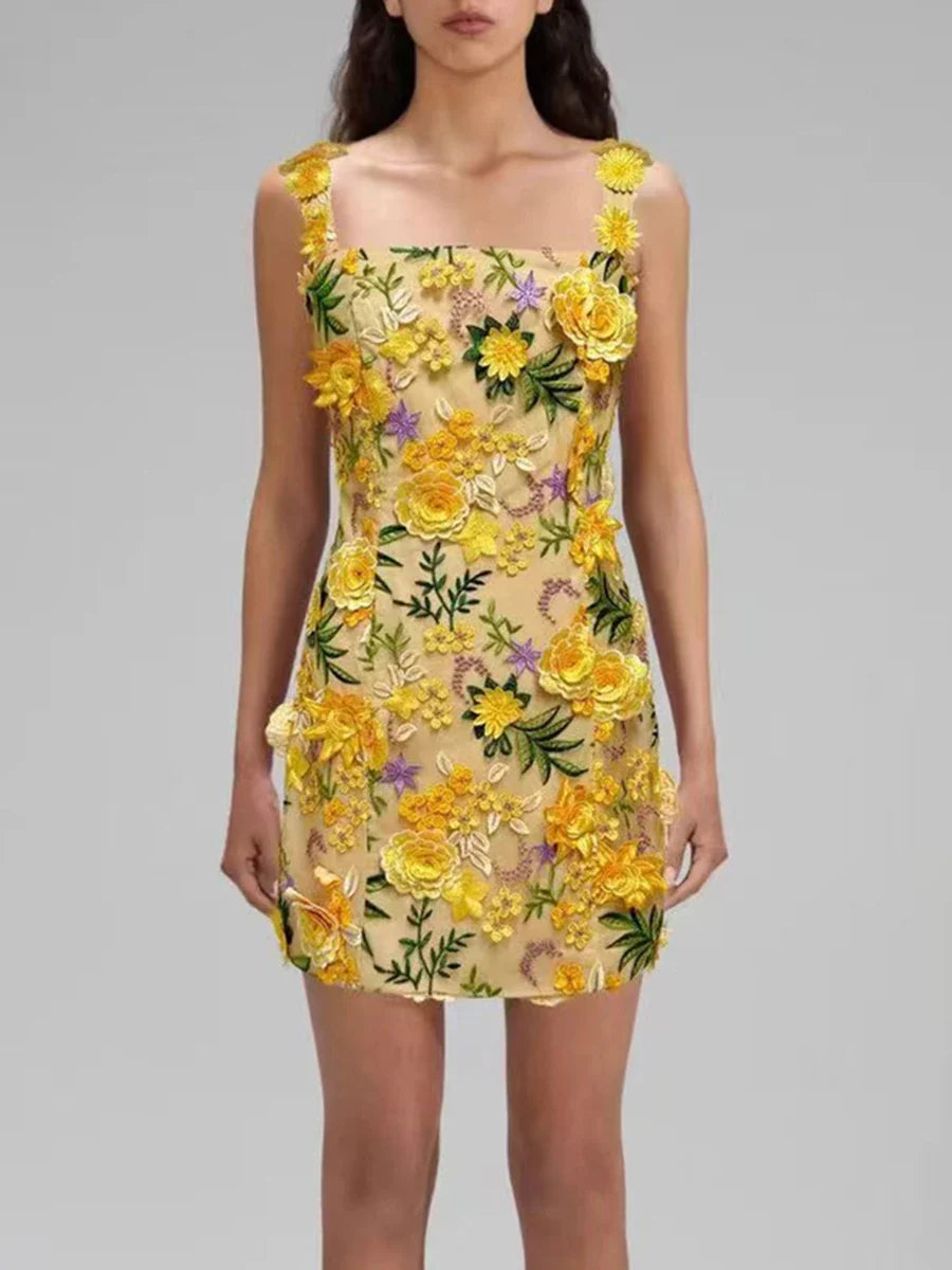 Woman wearing a yellow floral dress on a gray background