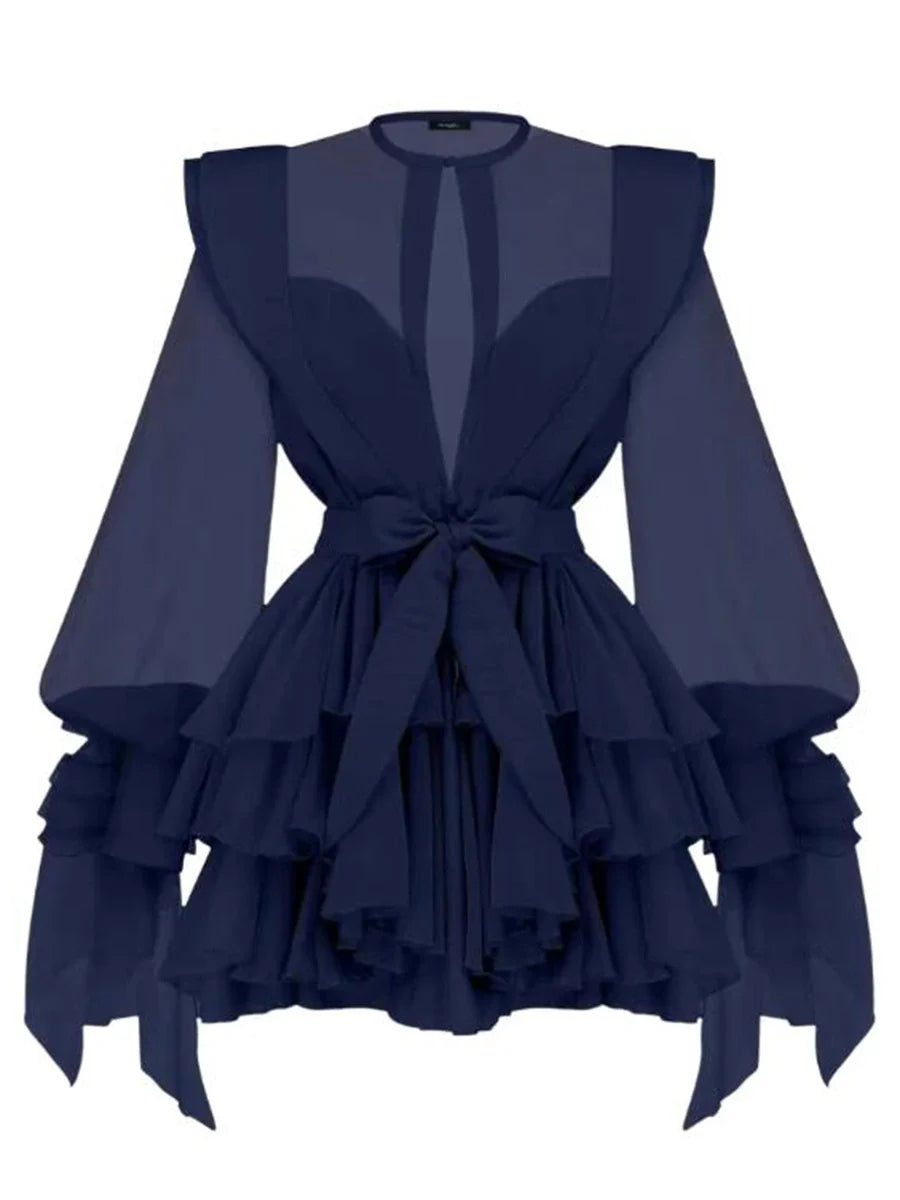 Navy blue dress with ruffled layers and sheer sleeves on a white background