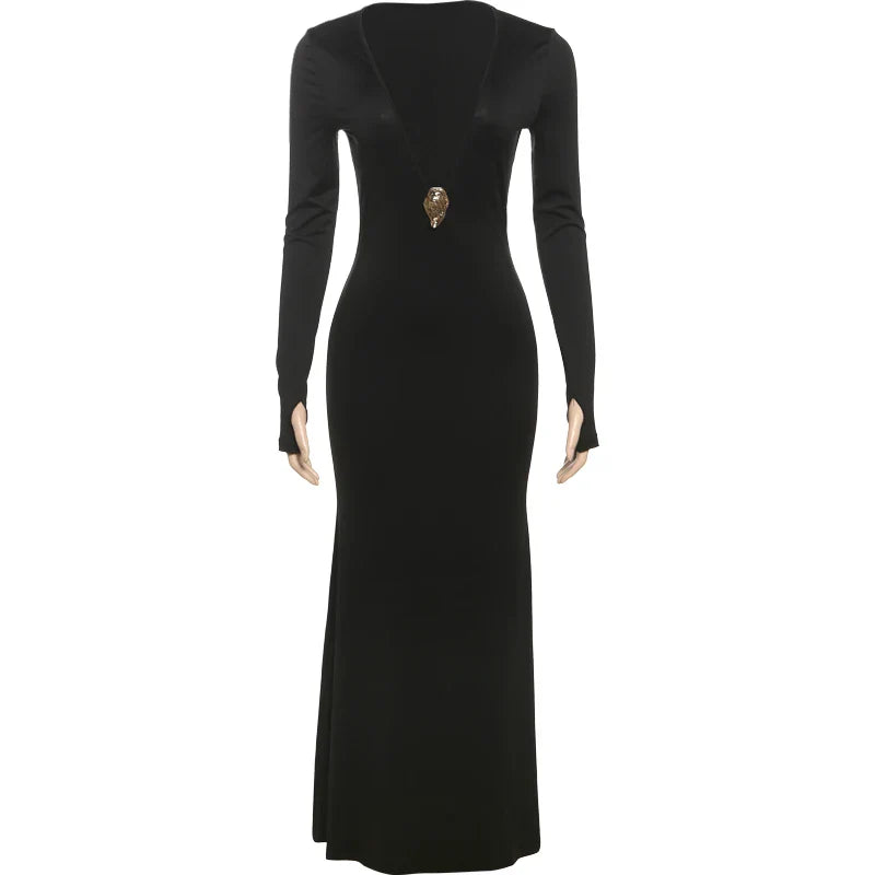 Black evening gown with long sleeves and a decorative brooch on a white background