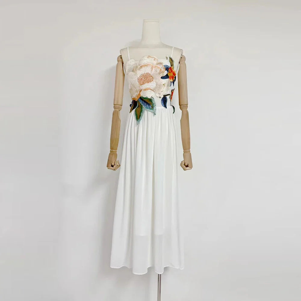 White dress with floral embroidery on a mannequin against a white background