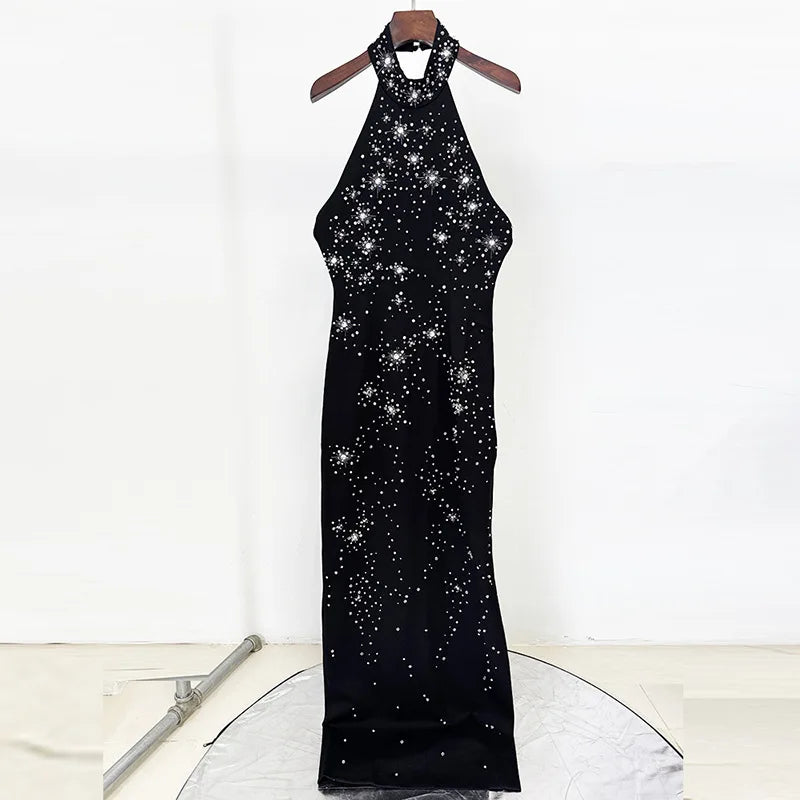 Black halter neck dress with star pattern on a white background