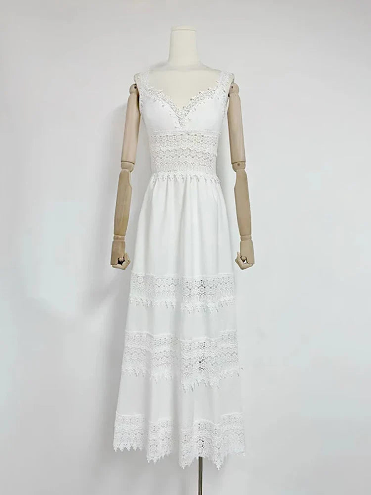 White lace dress on a mannequin against a plain background