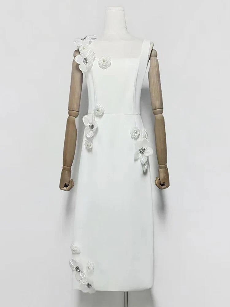 White dress with floral embellishments on a mannequin against a white background