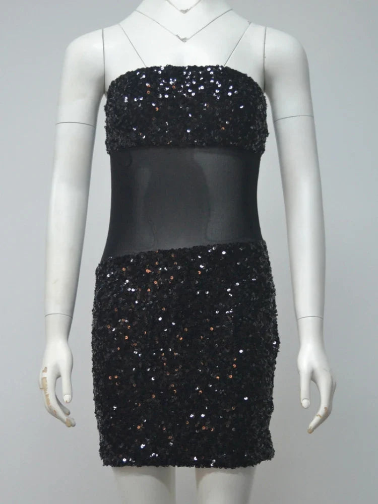 Black sequin dress on a mannequin against a gray background
