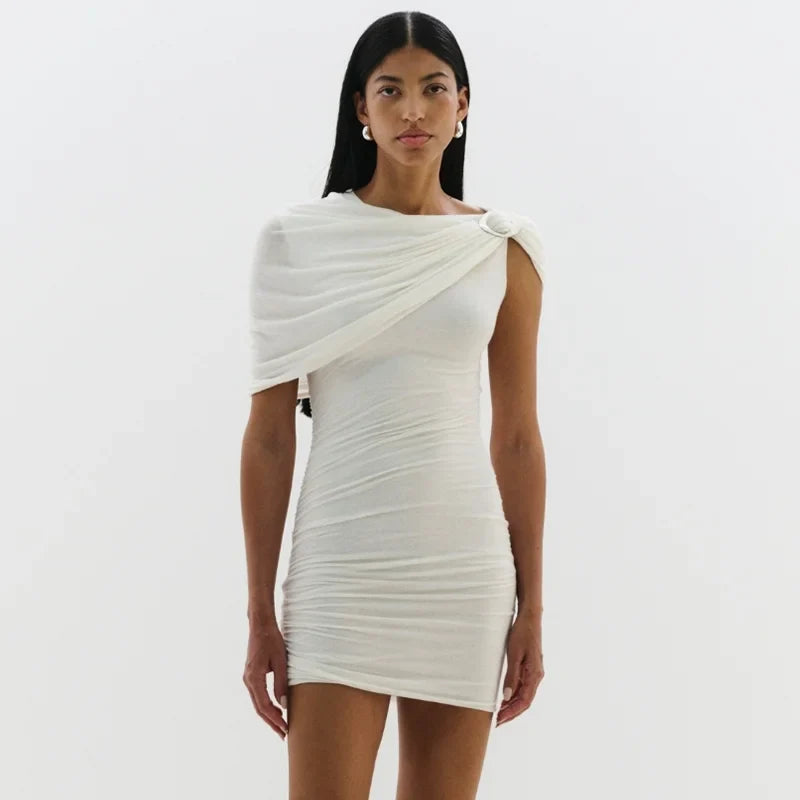 Woman wearing a white one-shoulder dress on a plain background