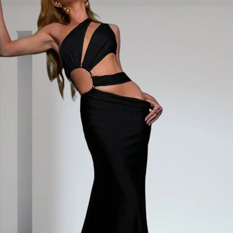 Black evening gown with cut-out design on a plain background