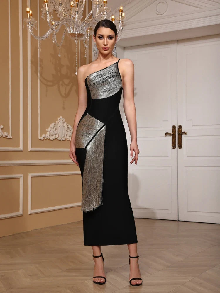 Woman wearing a black and silver one-shoulder dress in an elegant indoor setting.