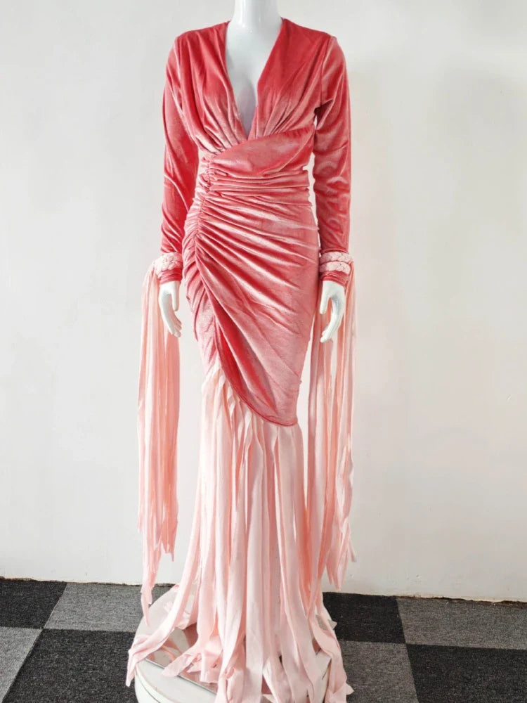 Pink velvet evening gown on a mannequin against a white wall.