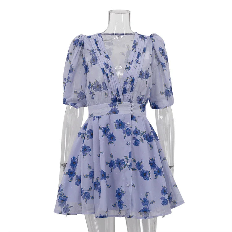 Blue floral dress on a mannequin against a white background