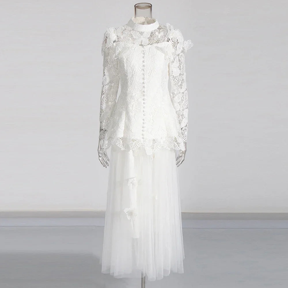 White lace dress on a mannequin against a plain background