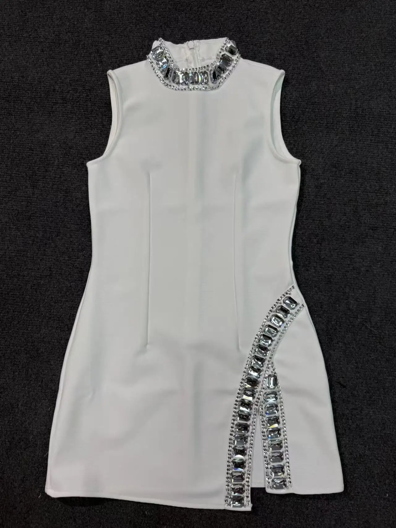 White dress with silver embellishments on a black background