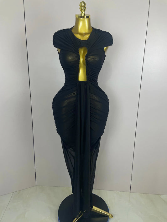 Black evening gown on a mannequin against a white background