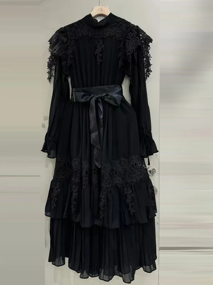 Black lace dress with a belt on a white background