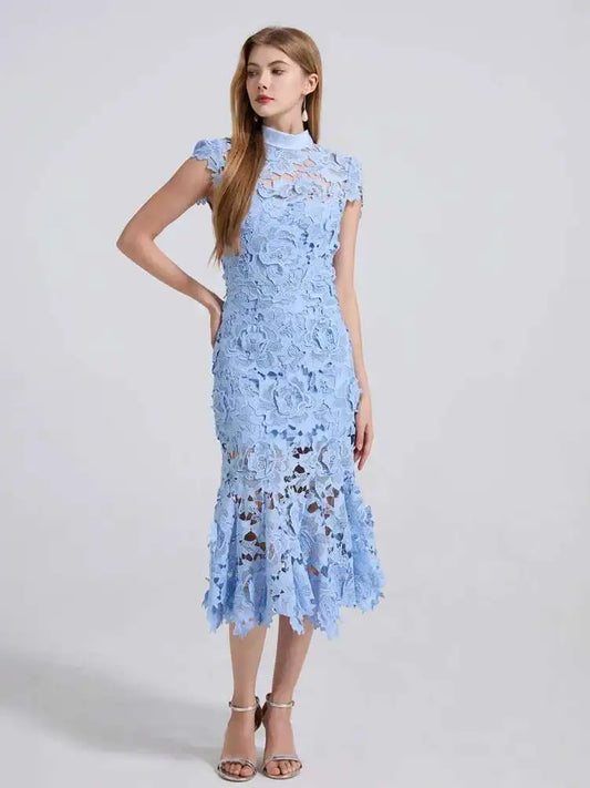 Woman wearing a light blue lace dress on a white background