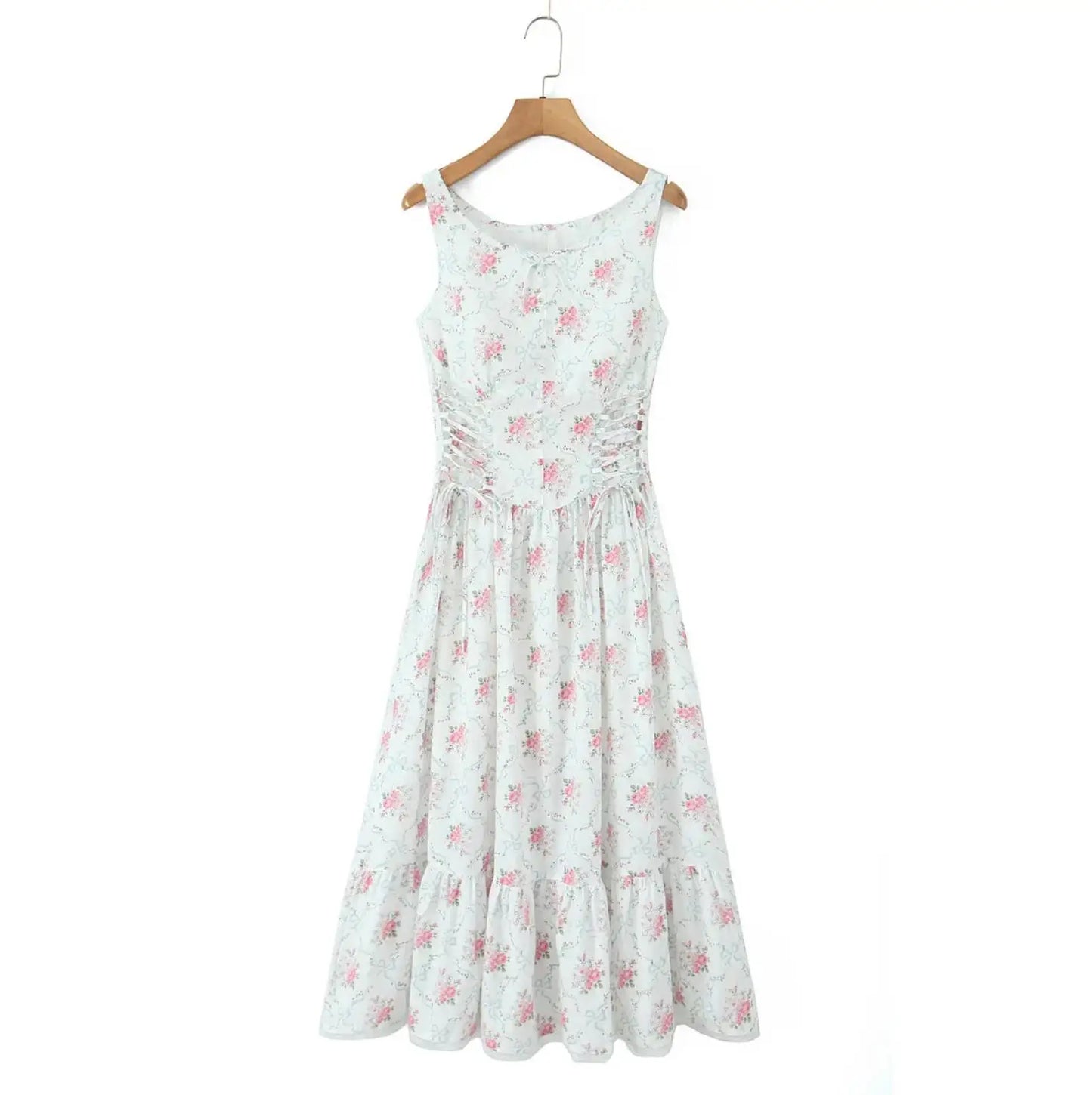White dress with pink floral pattern on a wooden hanger against a white background