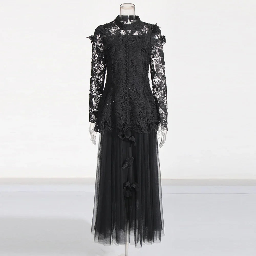 Black lace dress on a mannequin against a white background