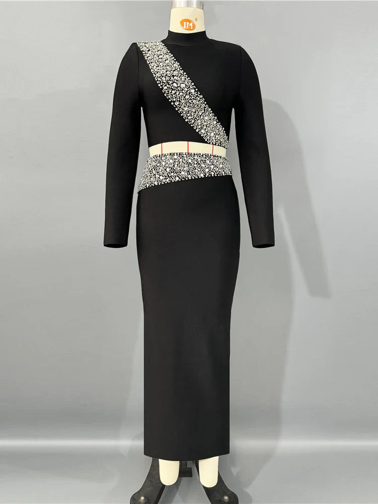 Black dress with silver embellishments on a mannequin against a gray background
