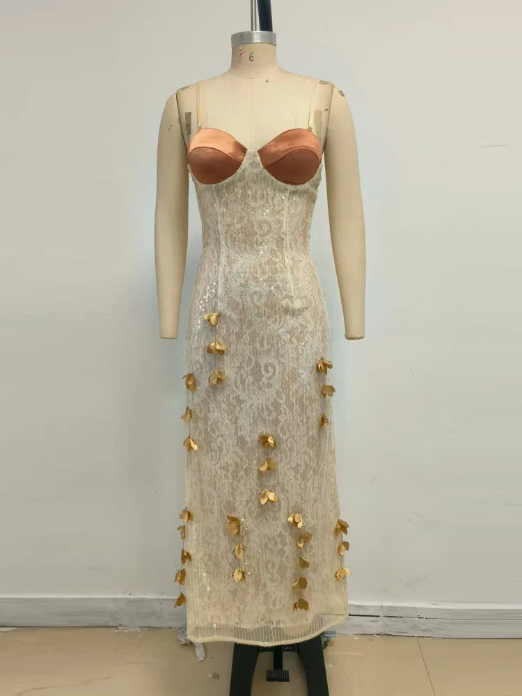 Mannequin wearing a beige lace dress with gold embellishments against a plain background