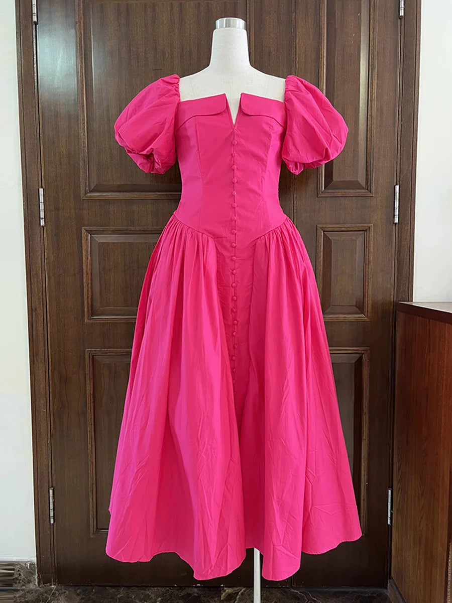 Pink dress on a mannequin against a wooden door background