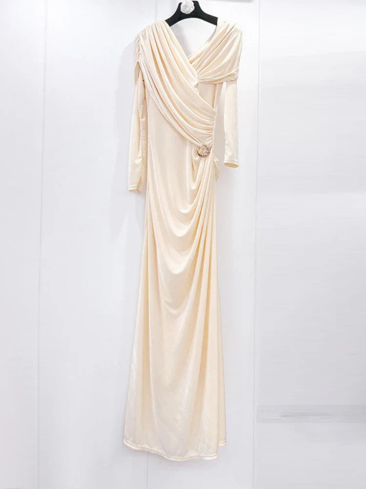 Beige evening gown on a hanger against a white background