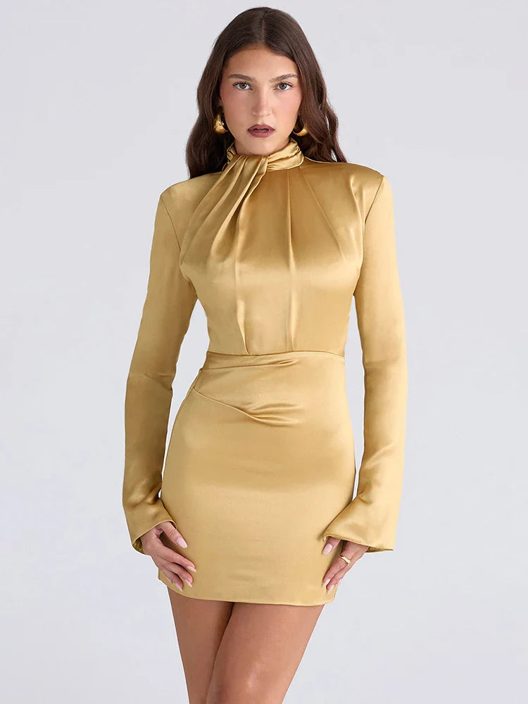 Woman wearing a gold dress against a light gray background