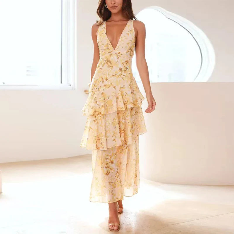 Woman wearing a yellow floral dress in a minimal indoor setting
