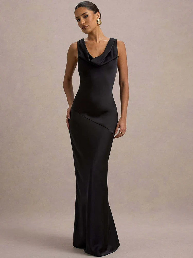 Woman wearing a black evening gown against a neutral background