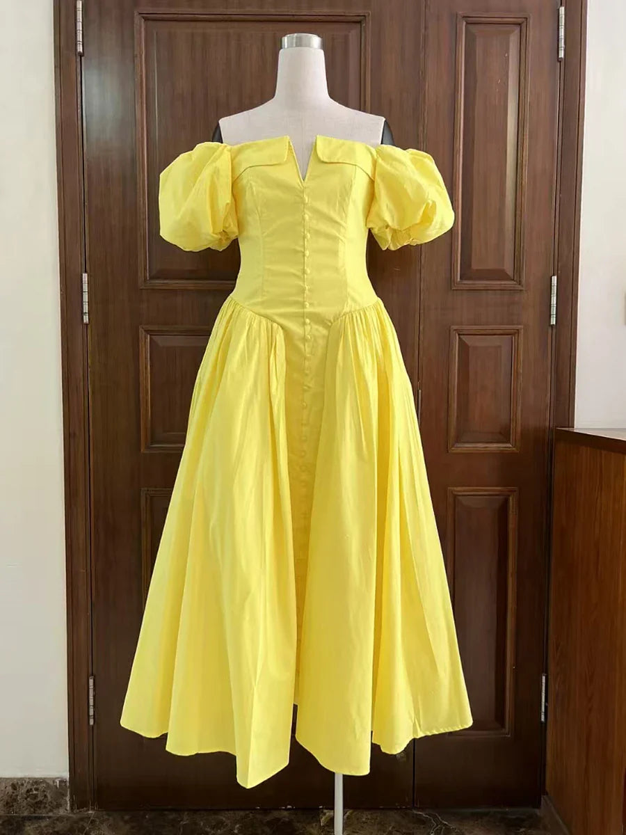 Yellow dress on a mannequin against a wooden door background