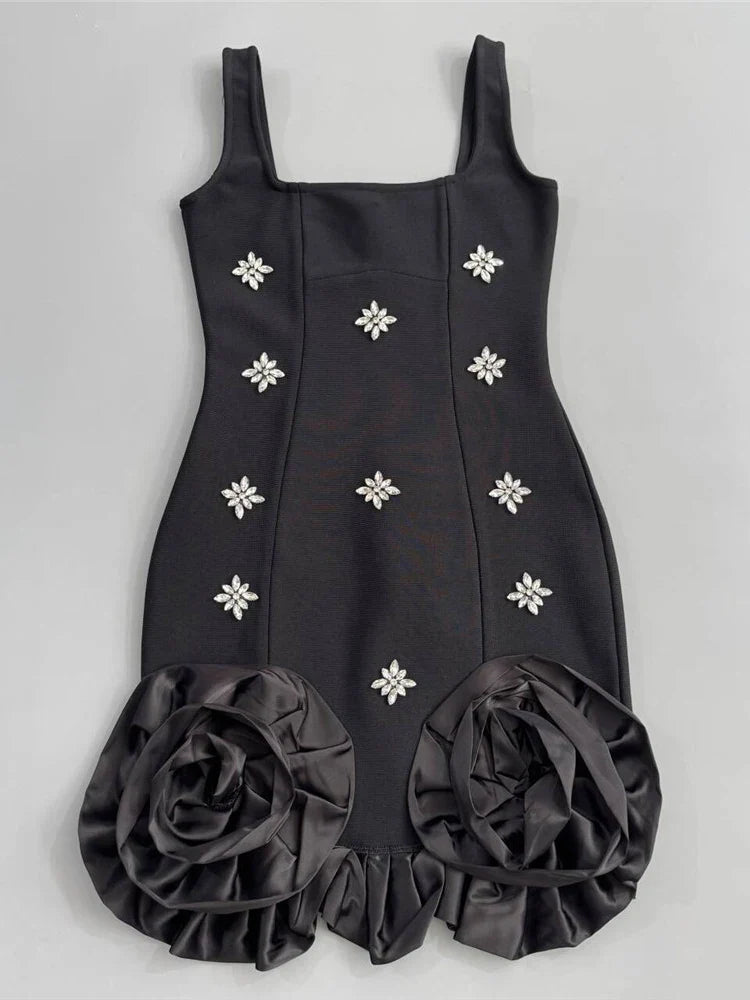 Black dress with floral embellishments on a gray background