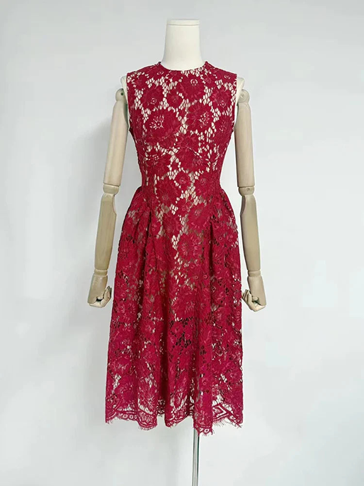 Red lace dress on a mannequin against a white background