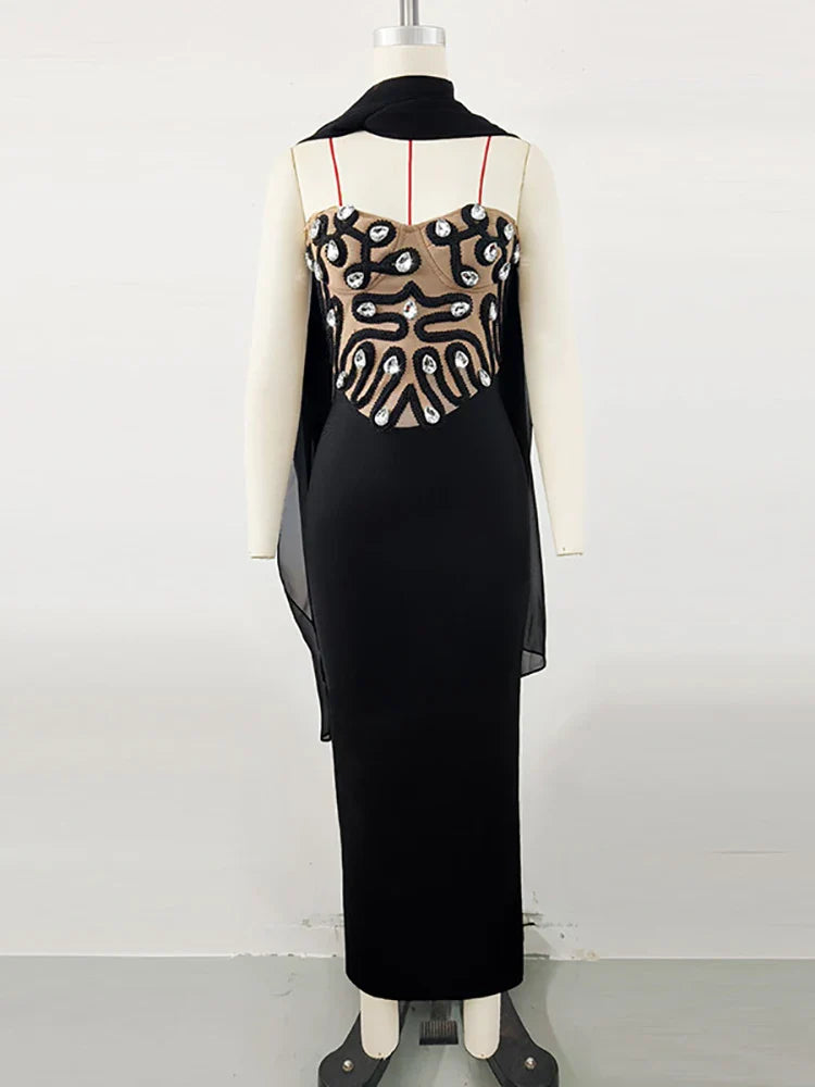 Black dress with patterned back on a mannequin against a white background