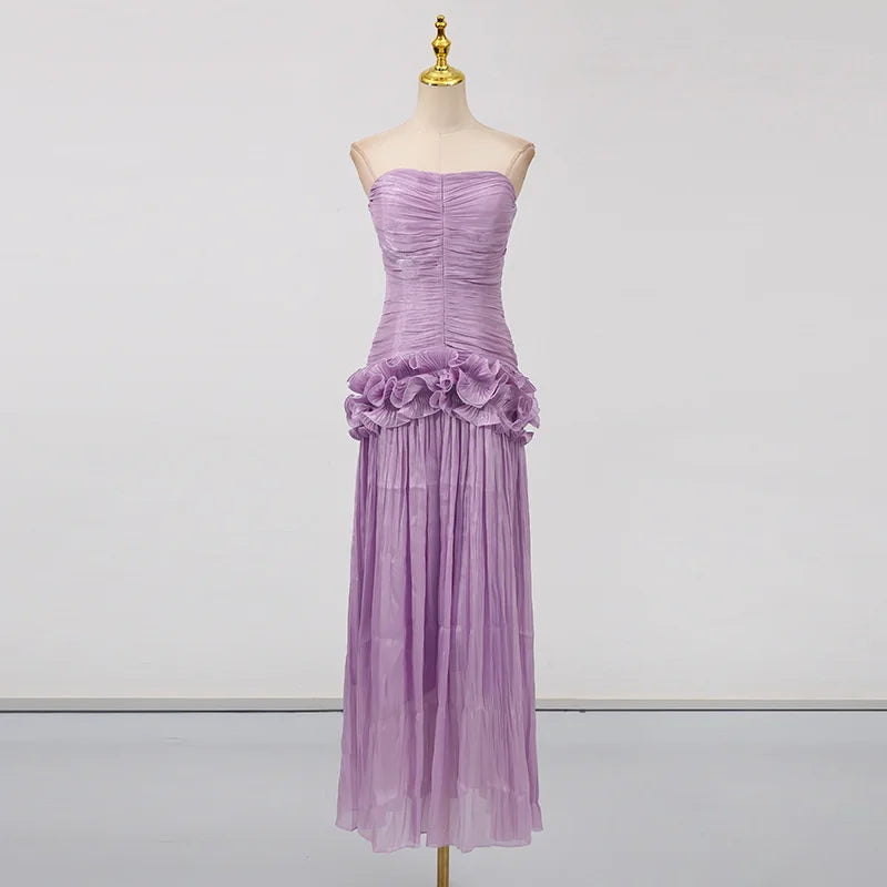 Purple evening gown on a mannequin against a plain background