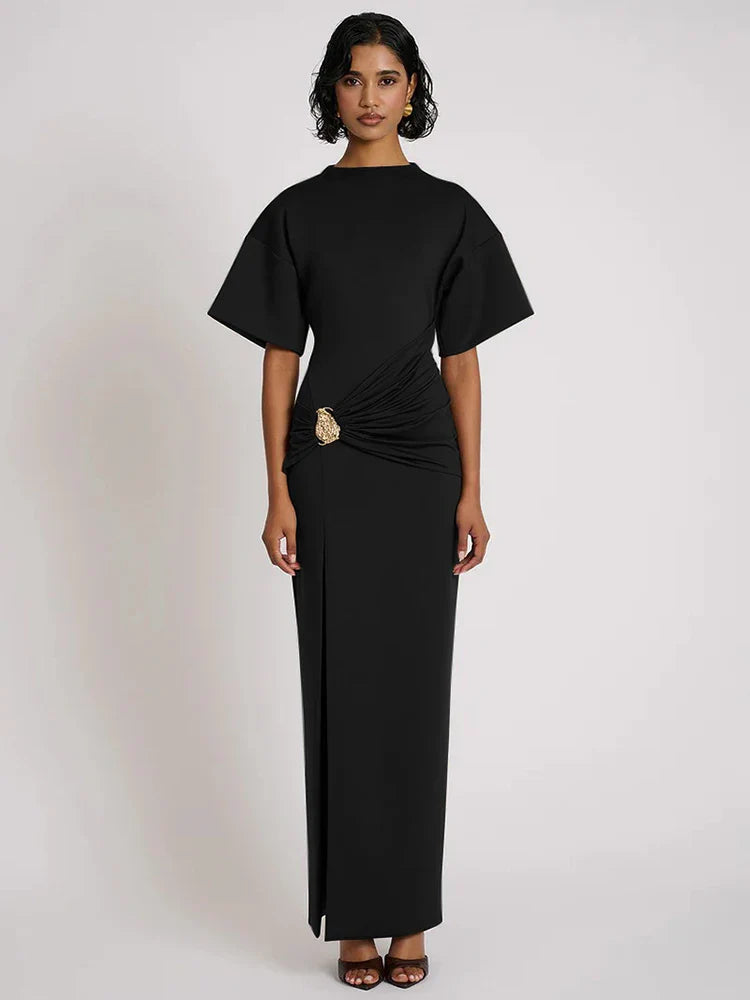 Woman wearing a black dress with a plain background