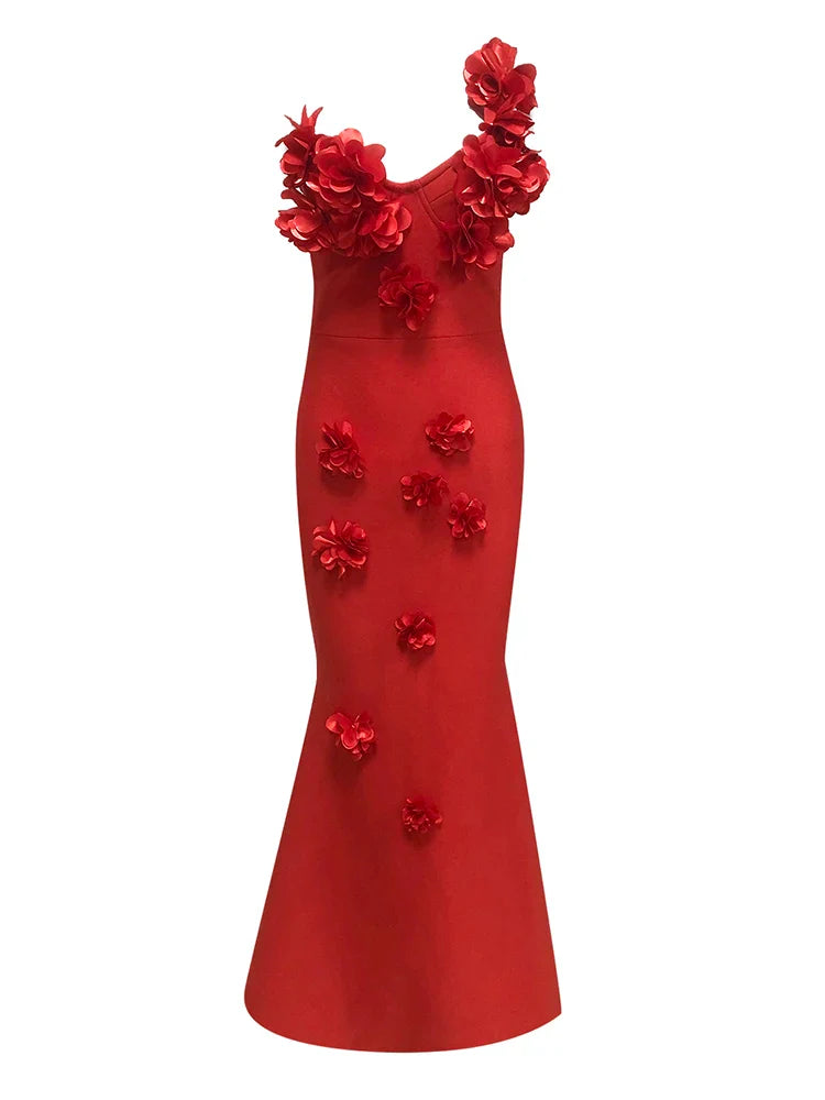 Red evening gown with floral embellishments on a white background