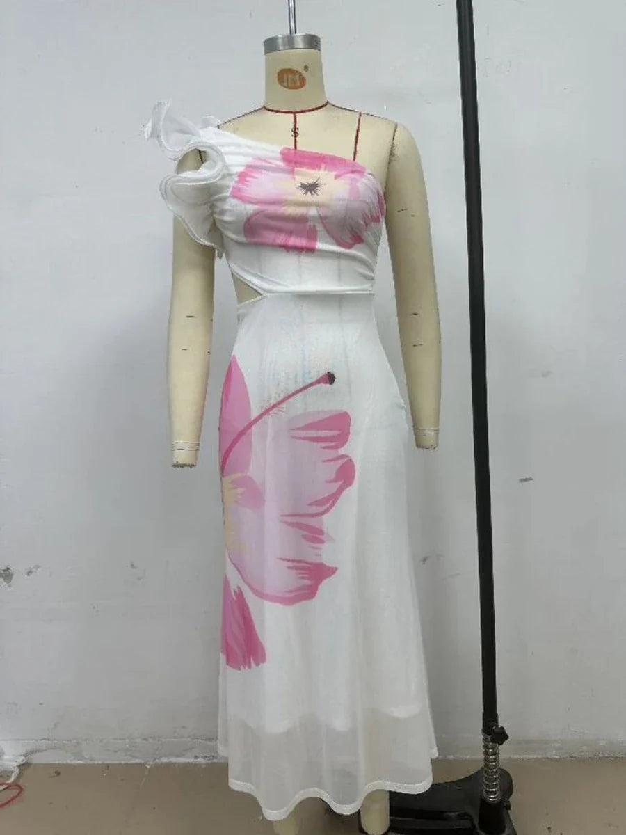 Mannequin wearing a white dress with pink floral patterns against a plain background