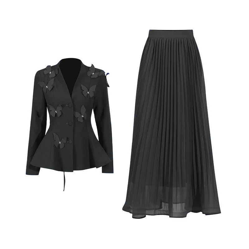 Black jacket with butterfly details and a black pleated skirt on a white background