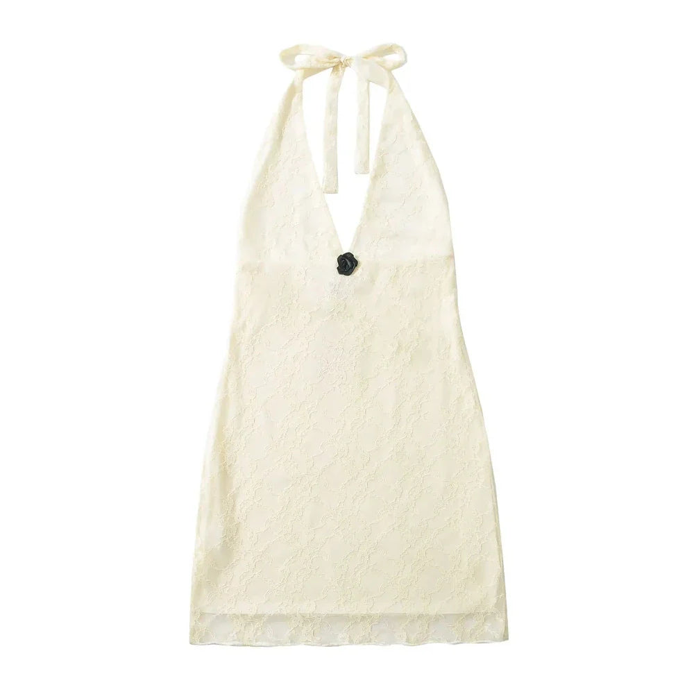 White halter top with black flower detail on a white background