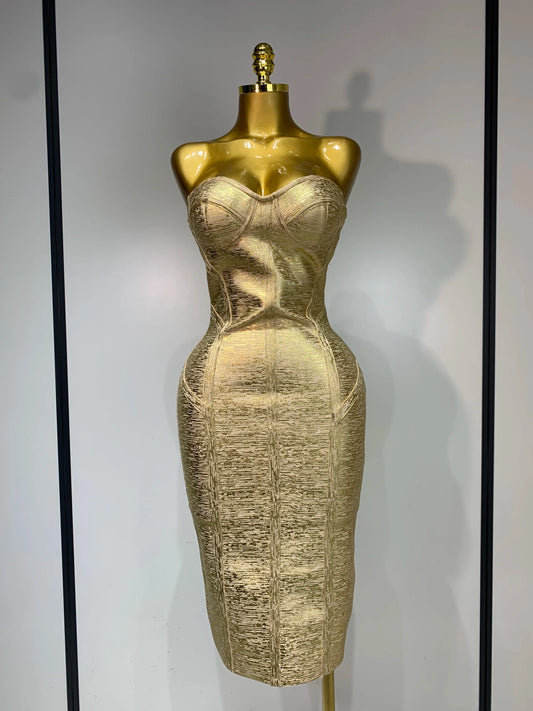 Gold dress on a mannequin against a gray background