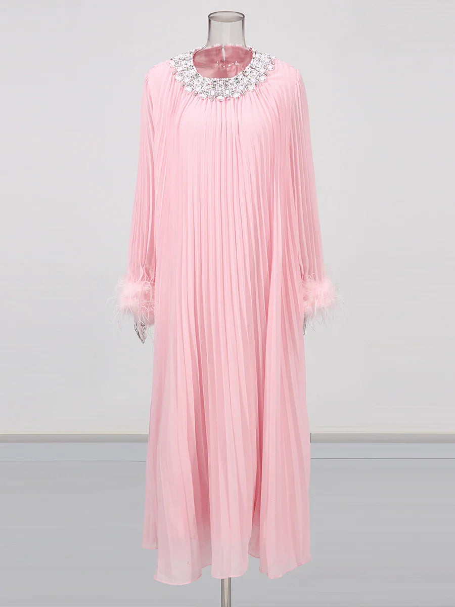 Pink pleated dress with a decorative neckline on a mannequin against a white background